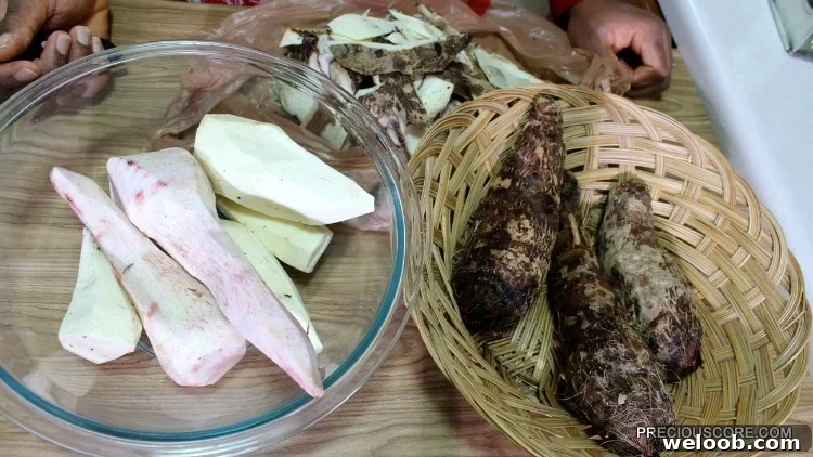 Bowls of peeled and unpeeled cocoyams.