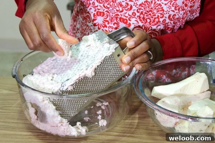 Grating ekwang on a box grater.