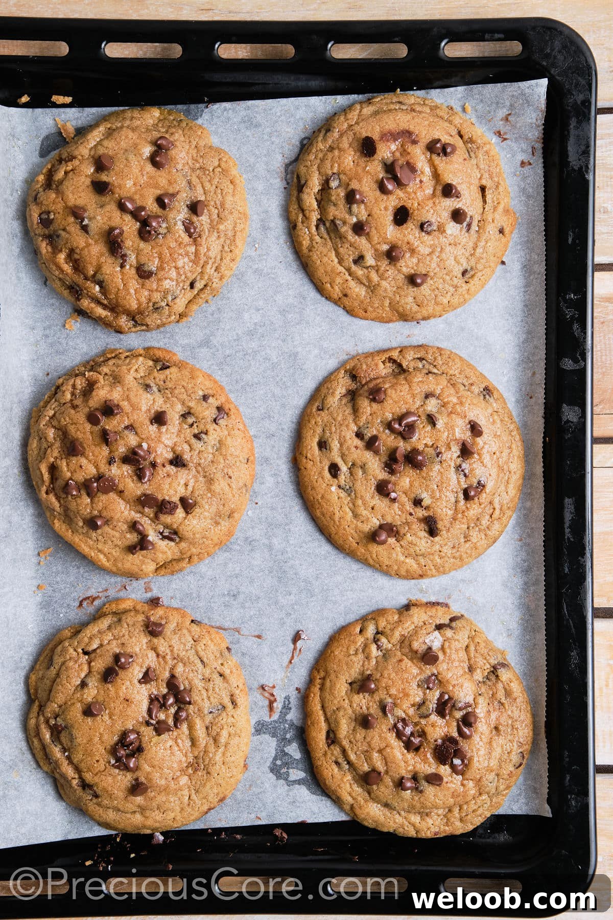 6 cinnamon chocolate chip cookies on a baking sheet.