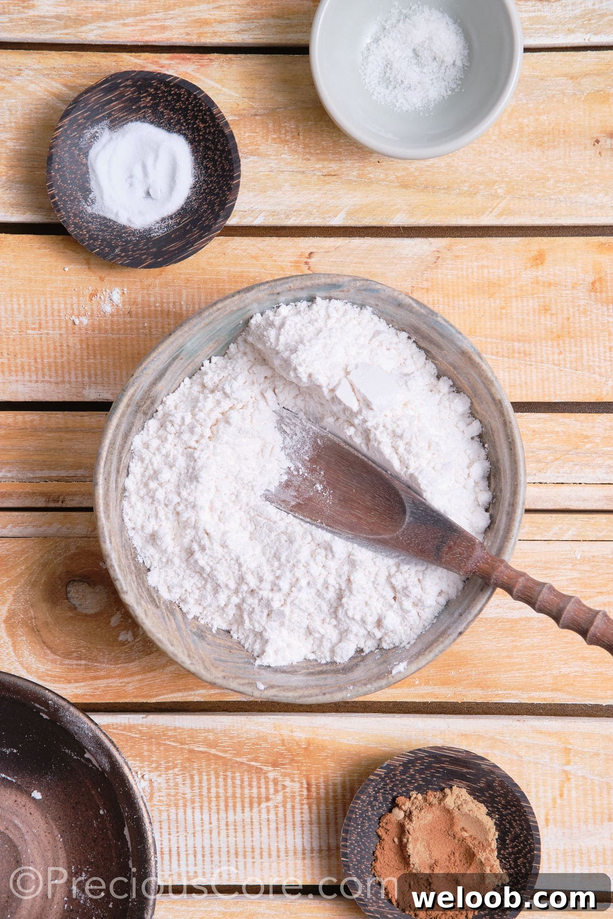 adding dry ingredients for the cookies to a bowl. 