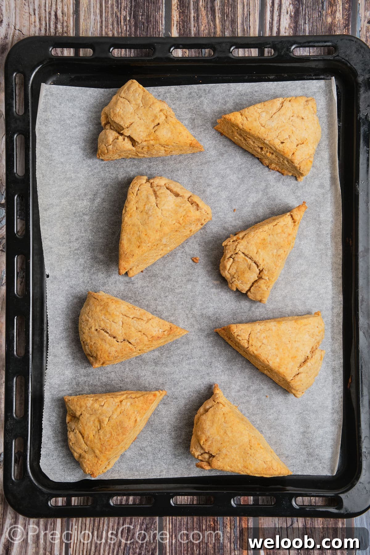 Buttery Sweet Potato Scones with Maple Glaze Recipe 14 Baked sweet potato scones on a baking sheet.
