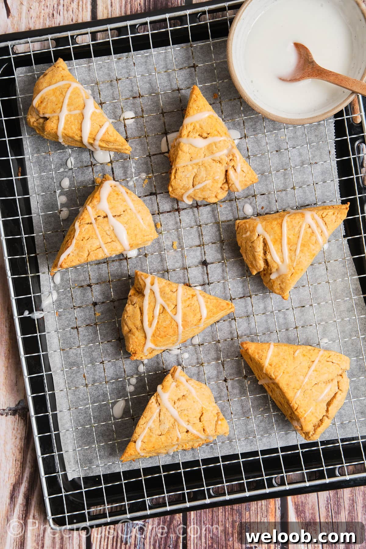 Buttery Sweet Potato Scones with Maple Glaze Recipe 16 Scones with glaze drizzled on them.