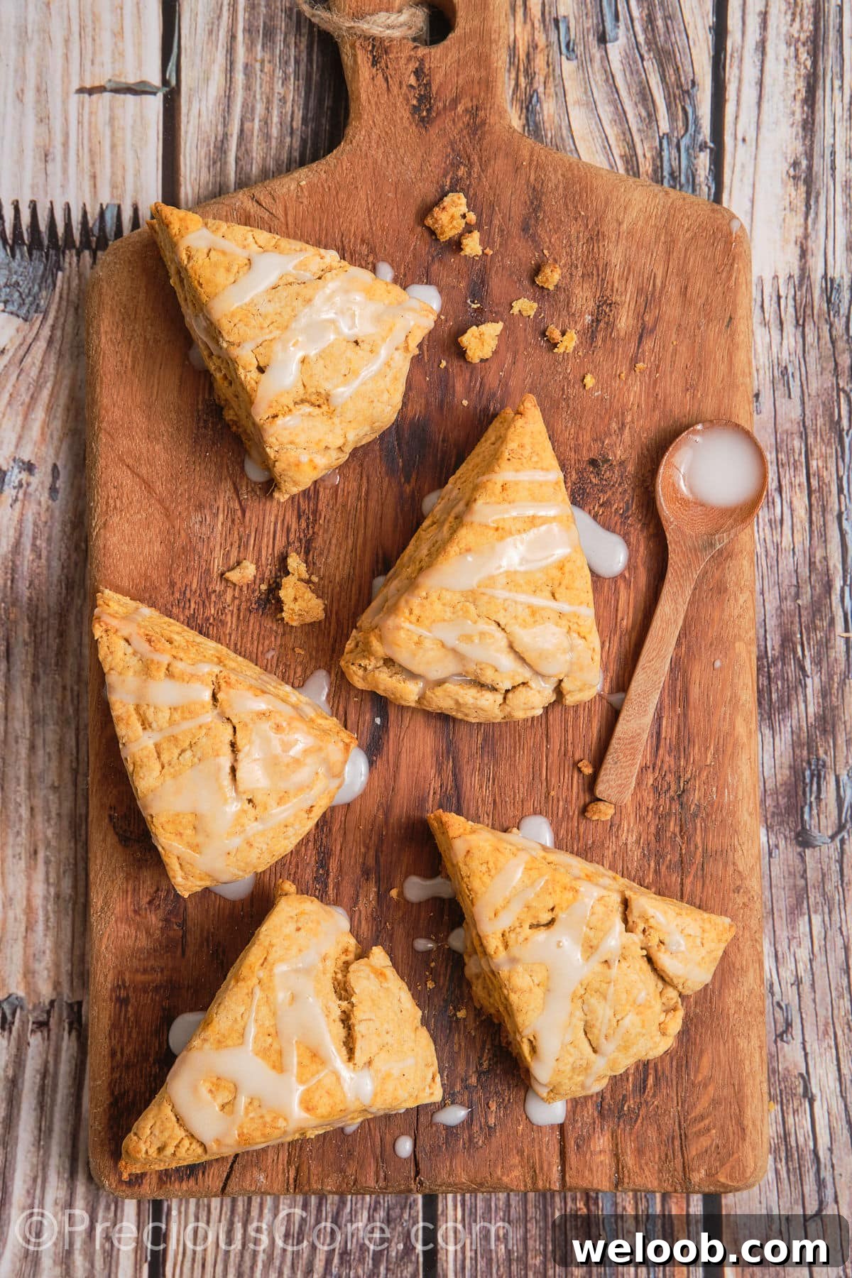 Buttery Sweet Potato Scones with Maple Glaze Recipe 17 Scones with white glaze drizzled on top.