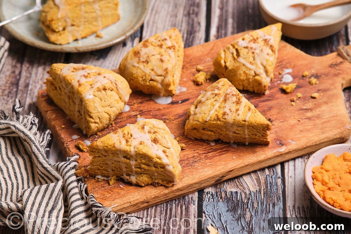 Buttery Sweet Potato Scones with Maple Glaze Recipe 3 The most delicious scones on a wooden chopping board.