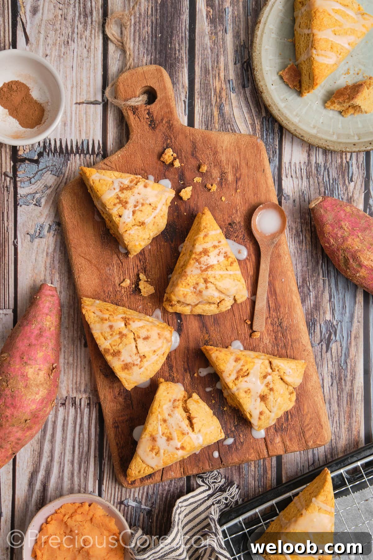 Buttery Sweet Potato Scones with Maple Glaze Recipe 5 Baked scones on a chopping board.
