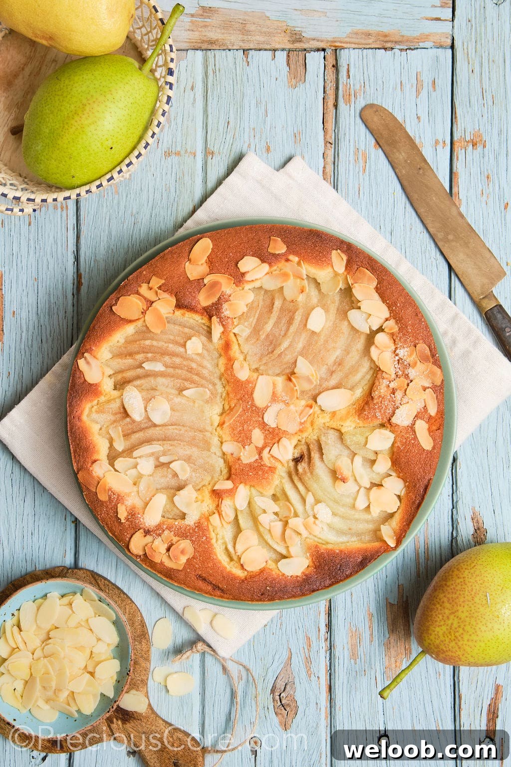 almond and pear cake on a serving plate.