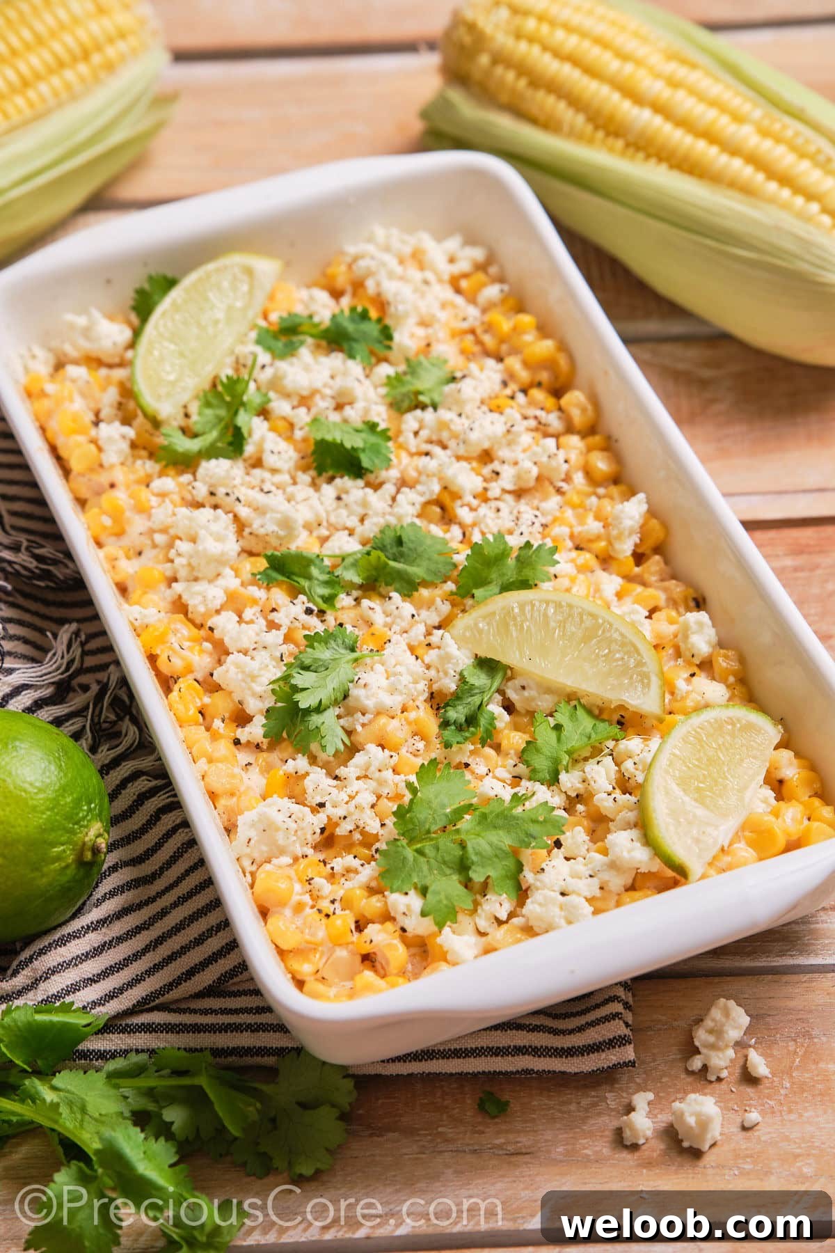 Street corn casserole in a white dish.