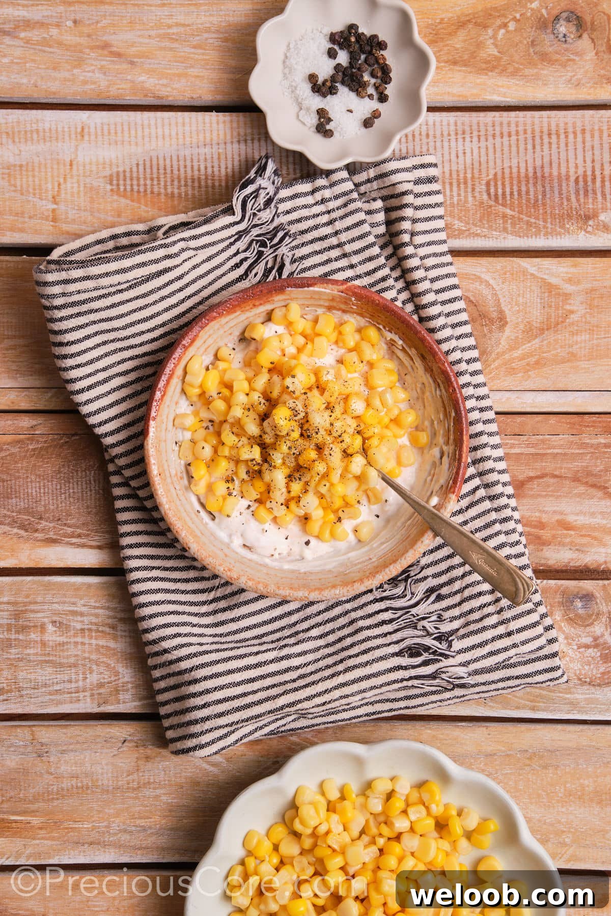 Mixing corn with a creamy sauce.