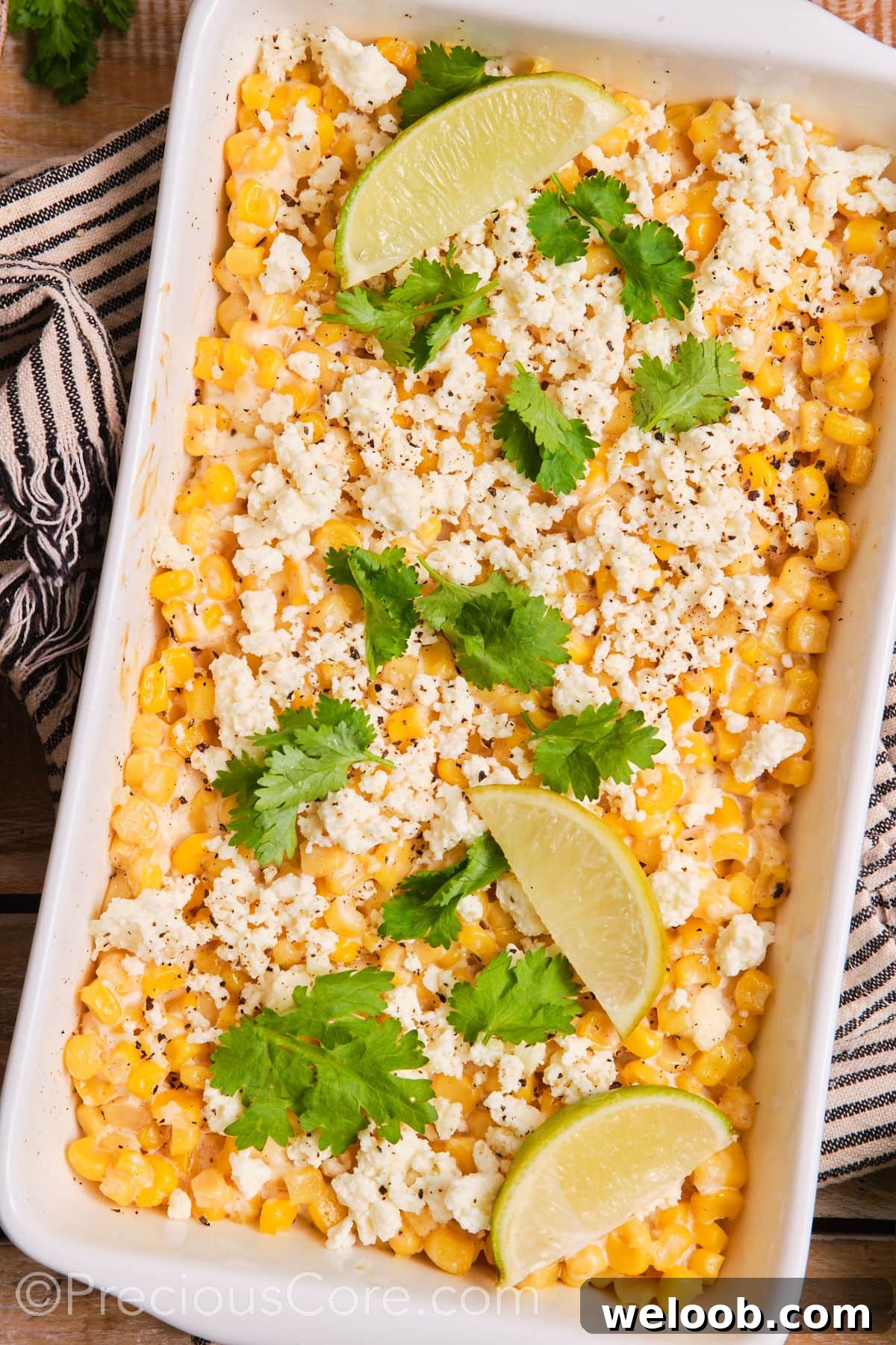 Mexican street corn casserole in a white baking dish.