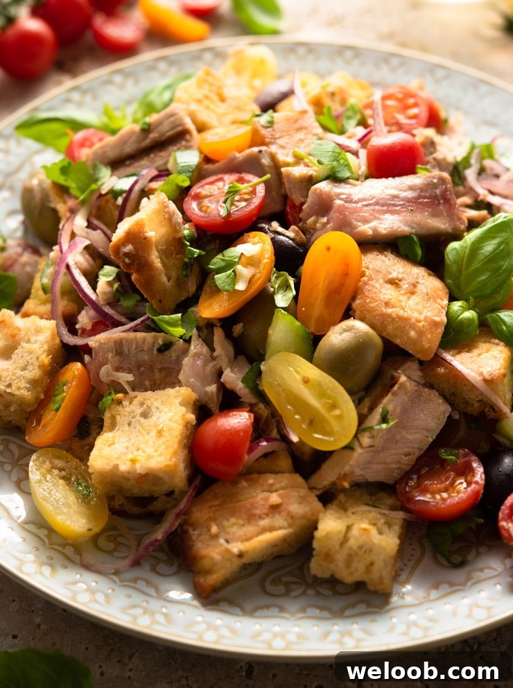 A close up of a tuna panzanella salad on a large serving plate
