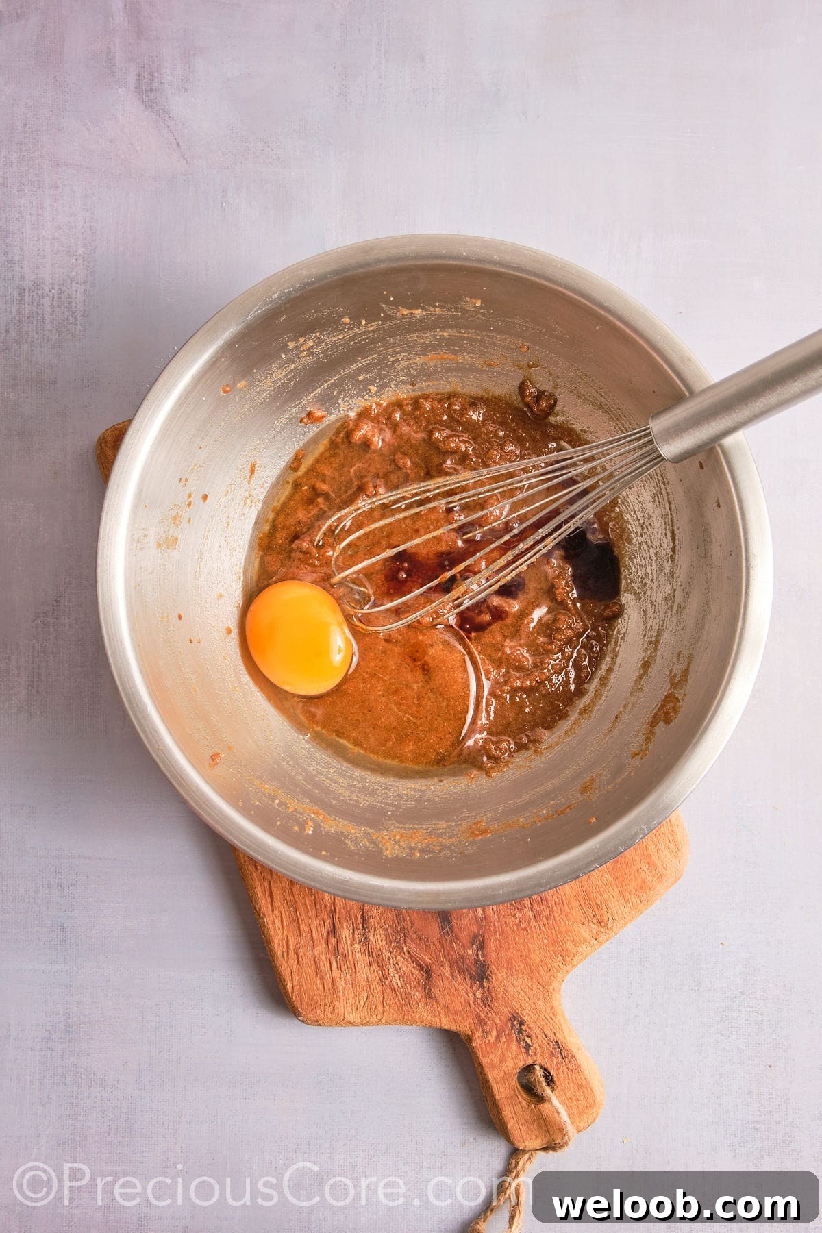 Adding egg and vanilla to the brown butter mixture.