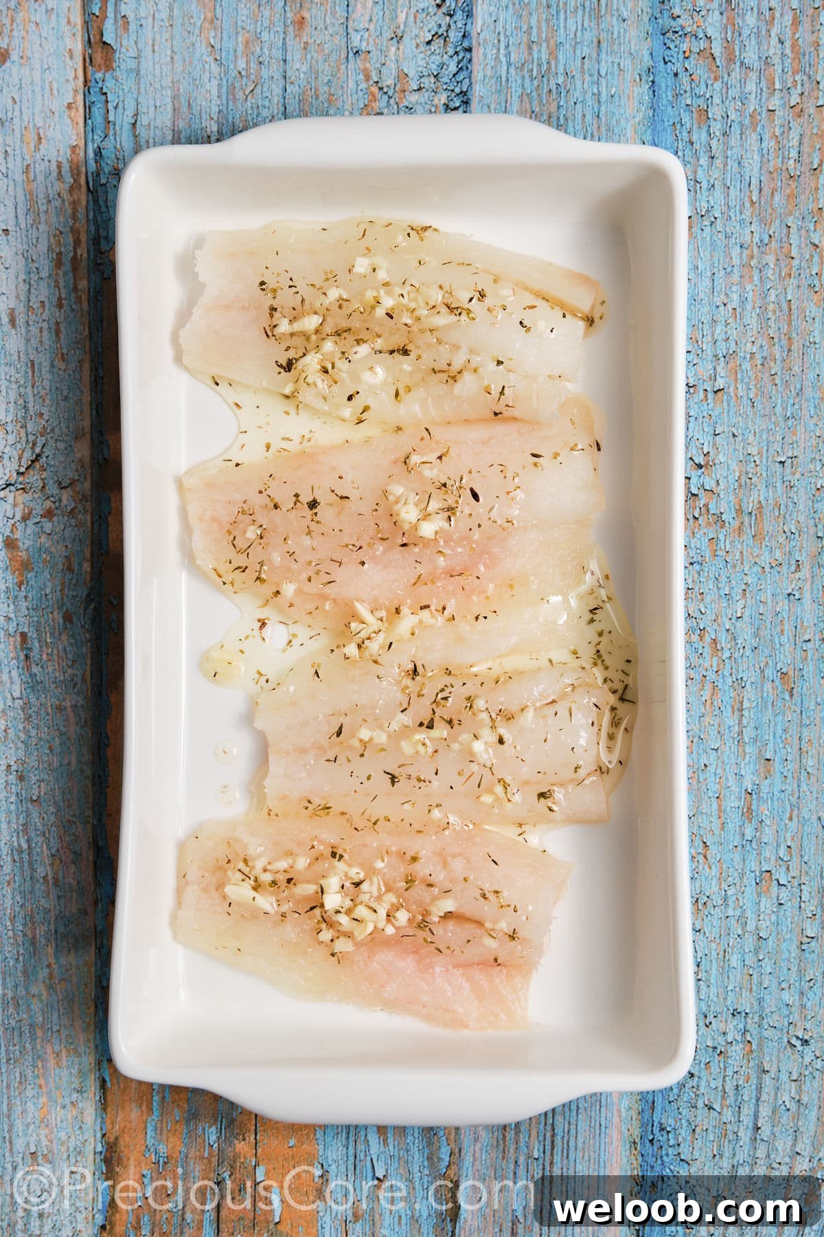 Cod fillets marinated in a pan. 