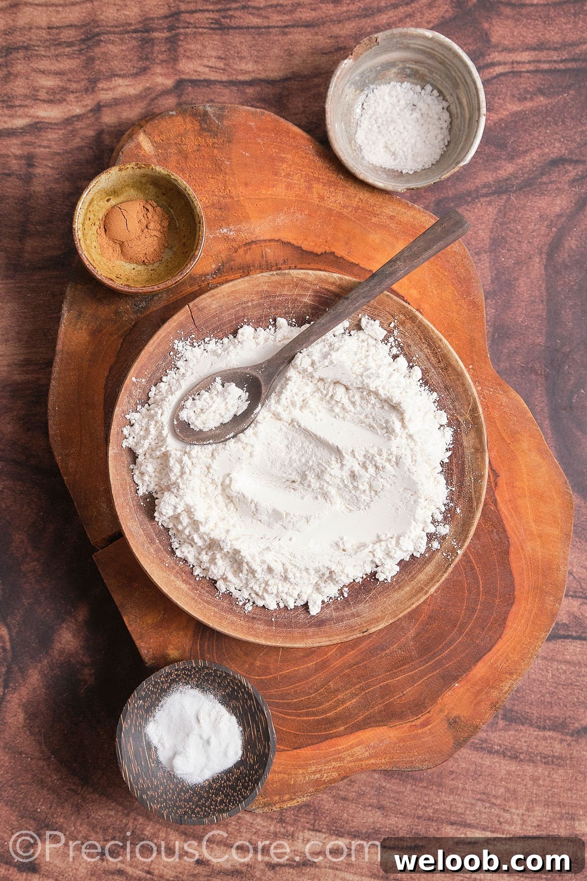 In a mixing bowl, take flour, baking soda, baking powder, salt, and cinnamon 