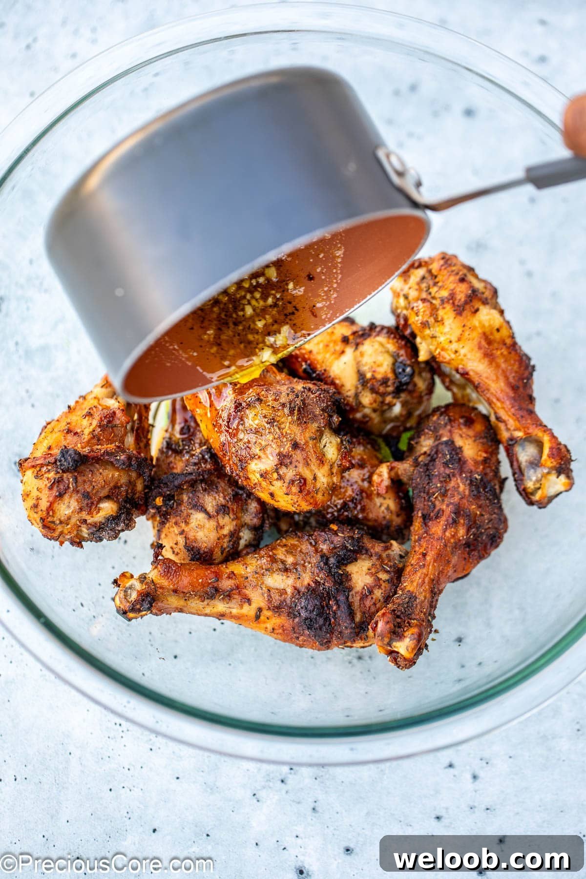 Lemon butter sauce being added to chicken.