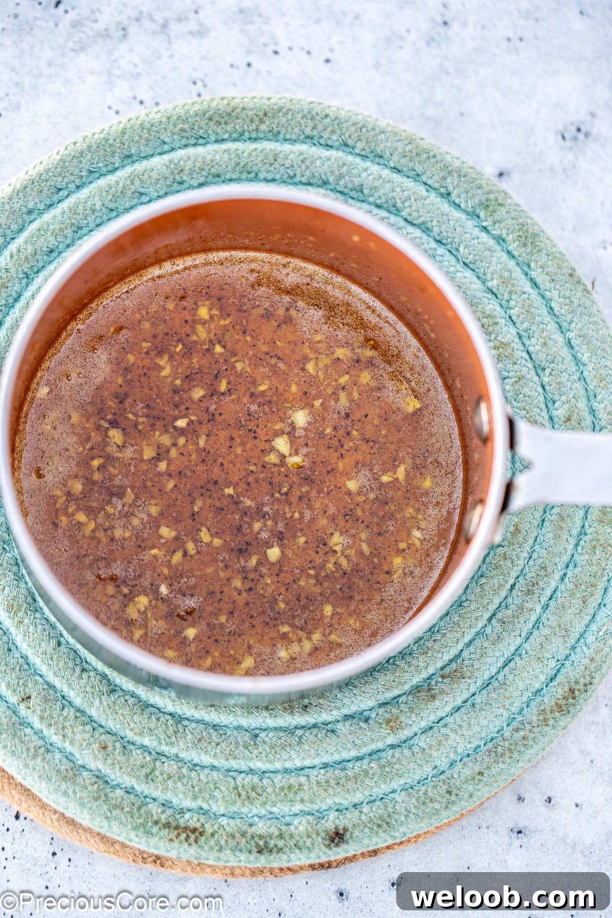 A small pot of lemon butter sauce.