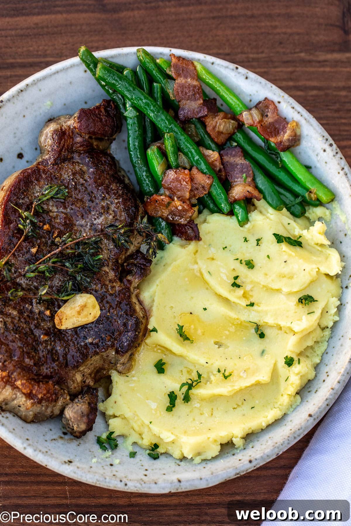 Bacon green beans served with steak and mashed potatoes.