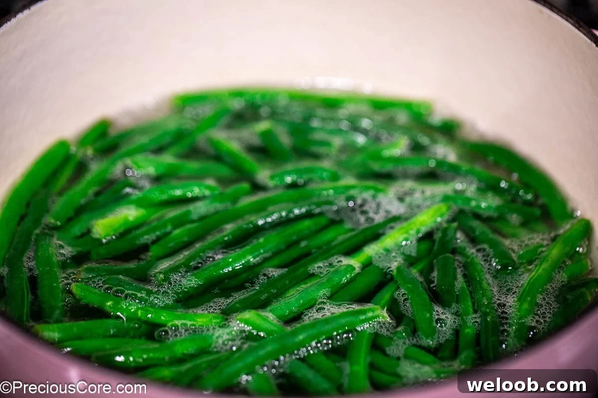 Green beans in a pot with water.
