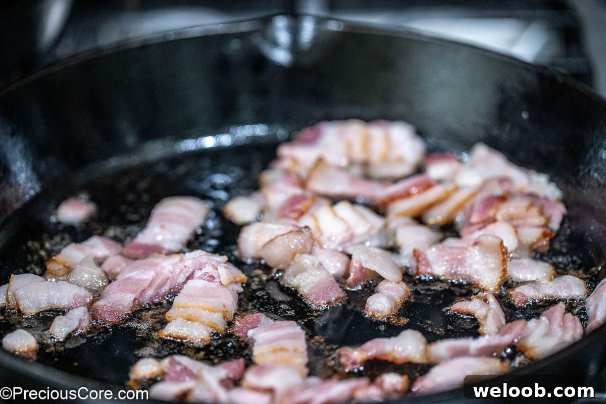 Bacon frying in a skillet.