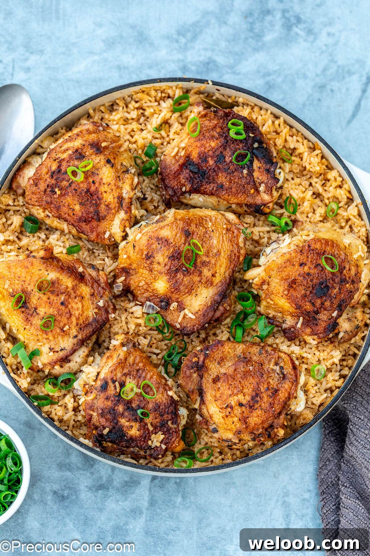 One pot chicken thighs and rice topped with chopped green onions.