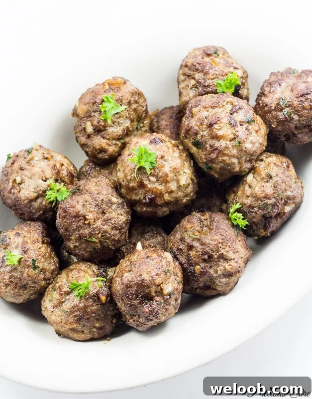 White dish of cooked meatballs.