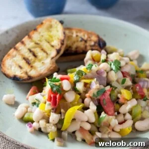A warm easy bean salad recipe with yellow pepper, eggplant, tomatoes, garlic and delicious fresh herbs. This makes a perfect easy, simple and delicoius dinner or lunch alongside some char grilled crusty bread. insidetherustickitchen.com