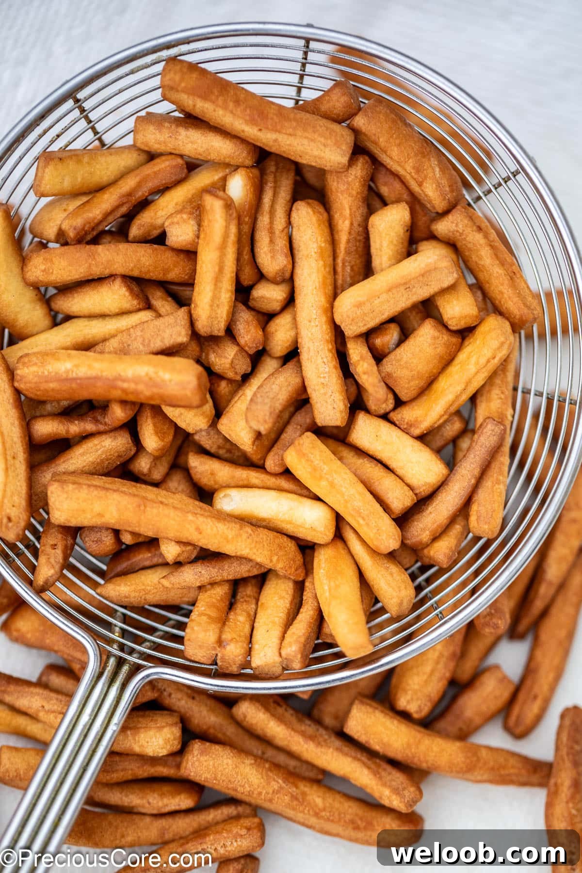 Crunchy Chin Chin in a frying spoon.
