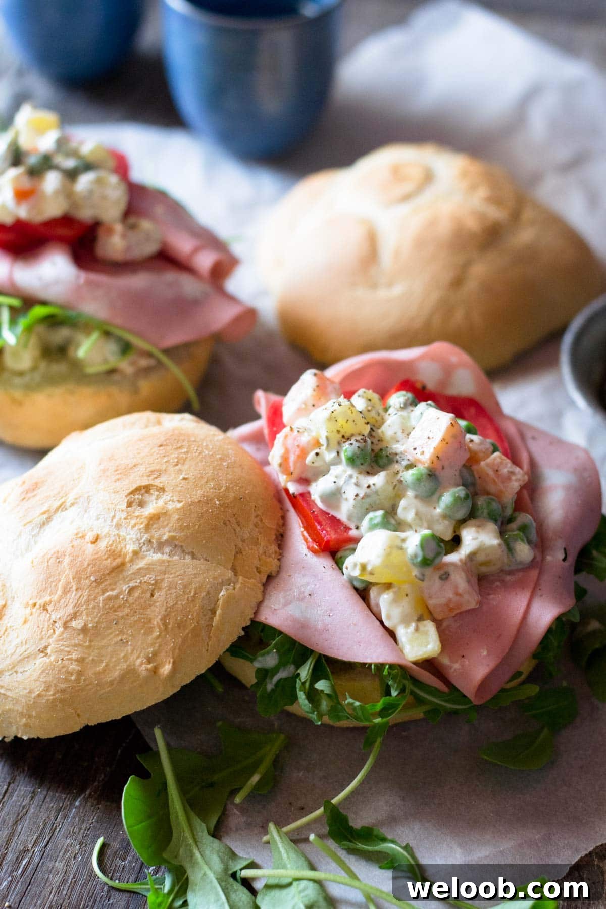 A close up of Russian salad on a bread roll