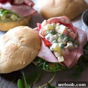 A close up of Russian salad on a roll