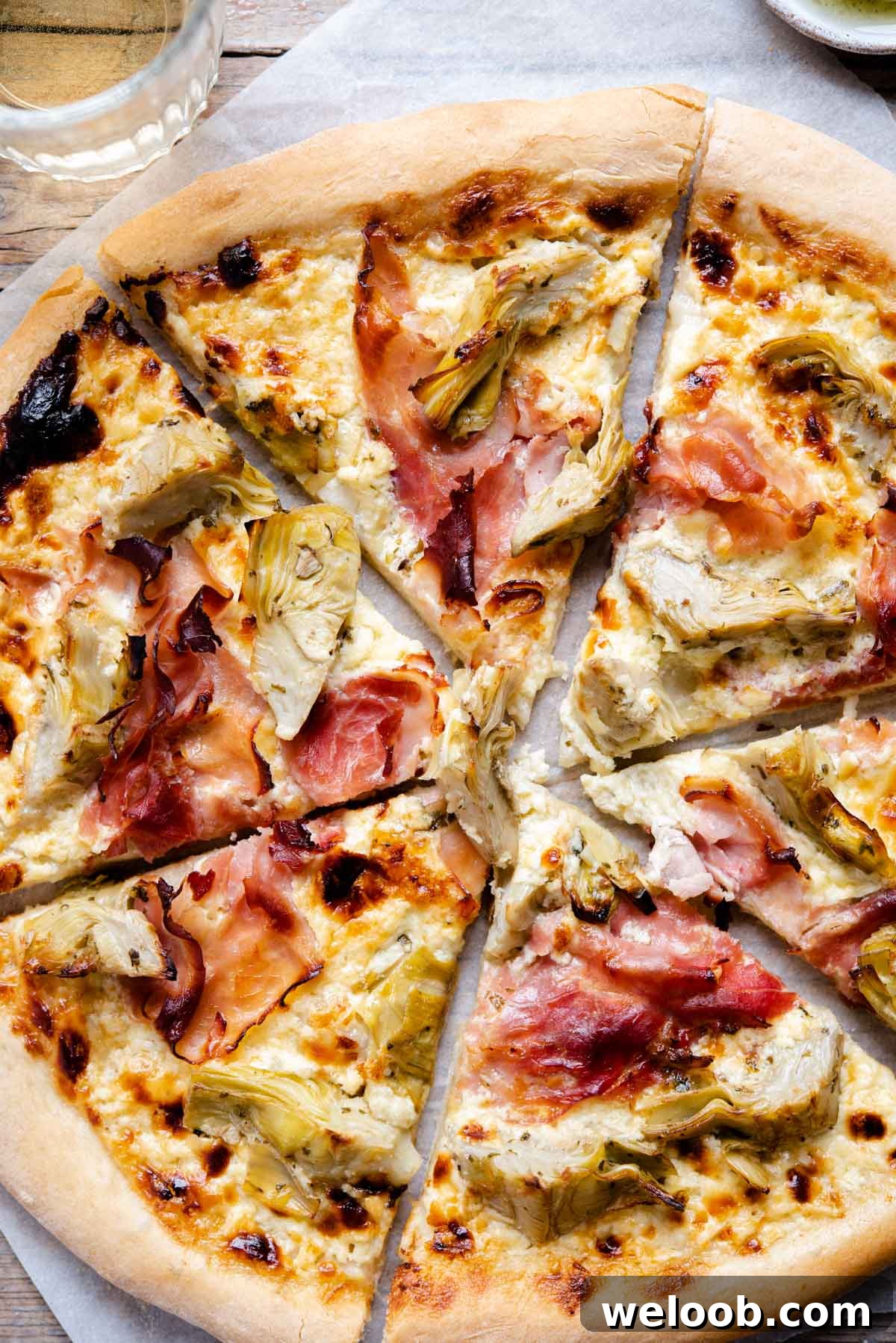 A close up of artichoke pizza with ham