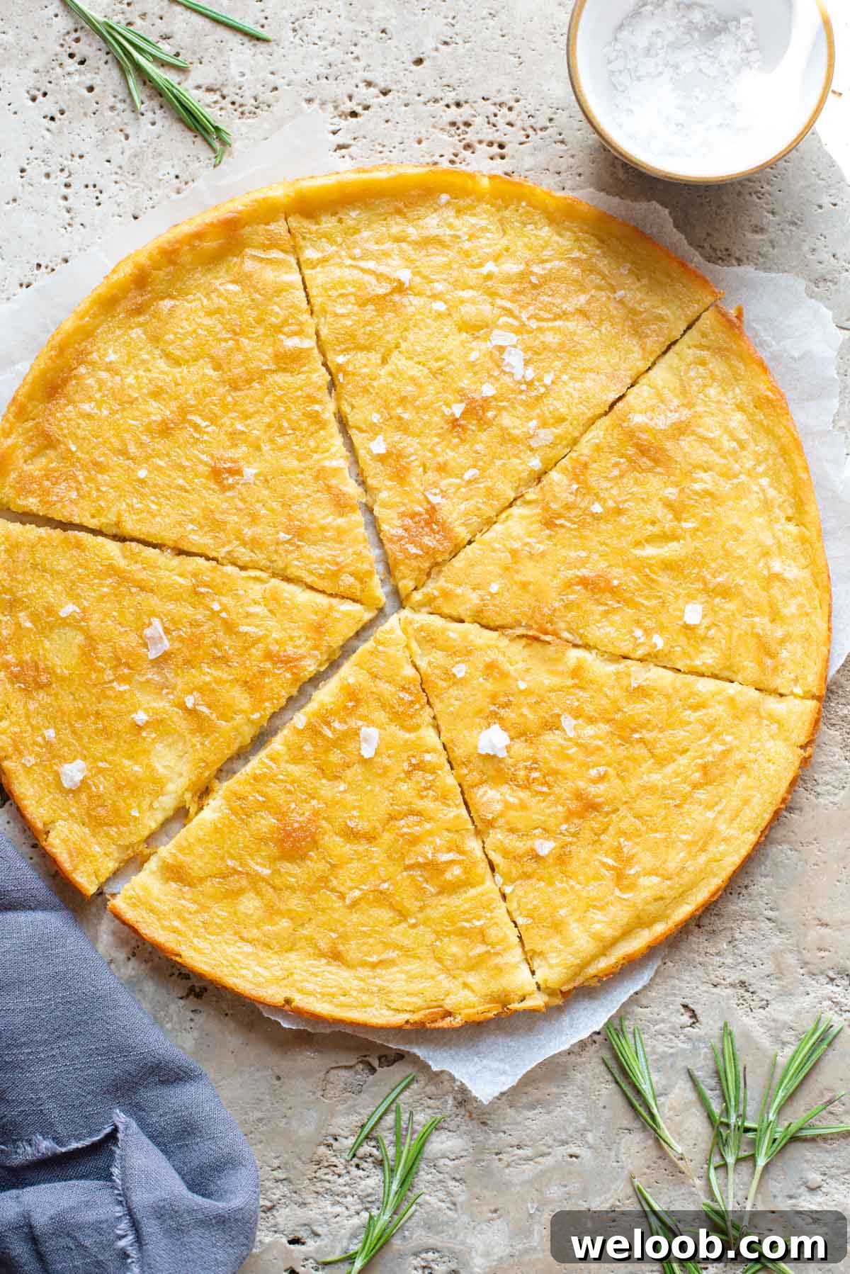 An overhead shot of a Tuscan chickpea flatbread on a stone worktop