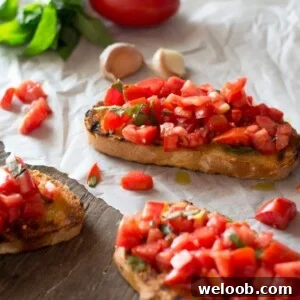 Bruschetta al pomodoro - classic Italian tomato bruschetta recipe made with ripe, juicy tomatoes, fresh basil and extra virgin olive oil. Served on char grilled, garlic toasts, this one is always a winner! Inside the rustic kitchen