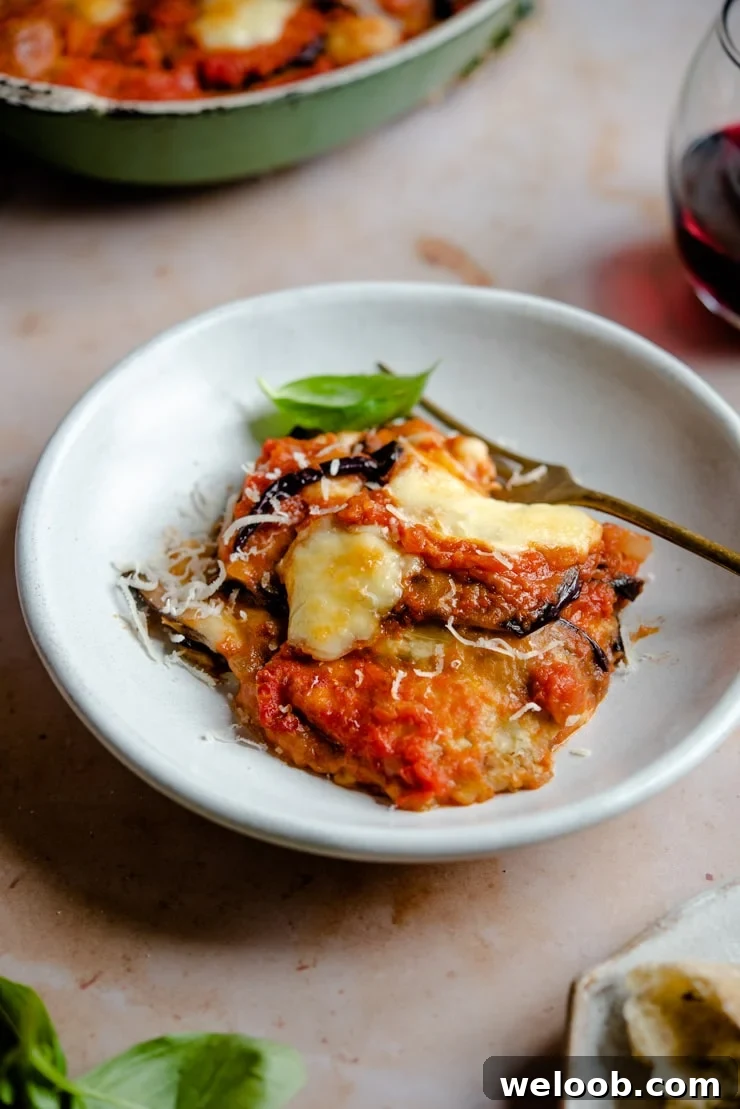 Eggplant parmigiana in a bowl with a fork