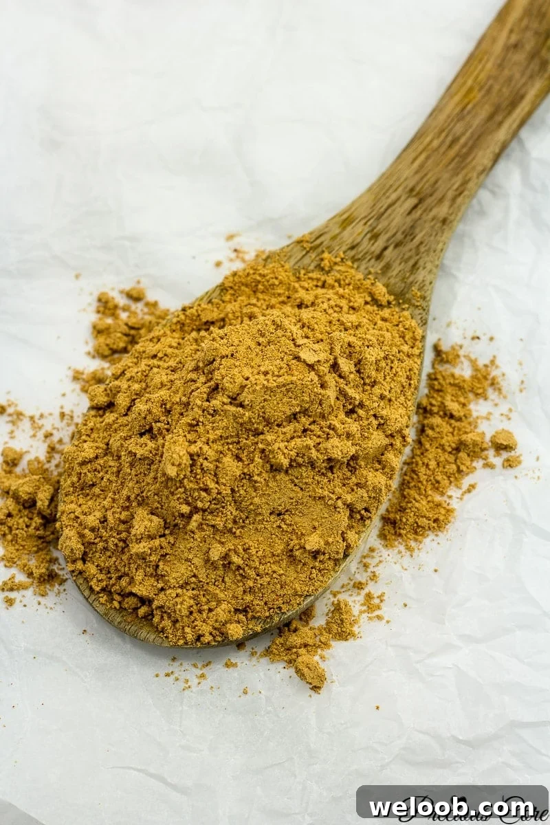 Suya spice on a wooden spoon.