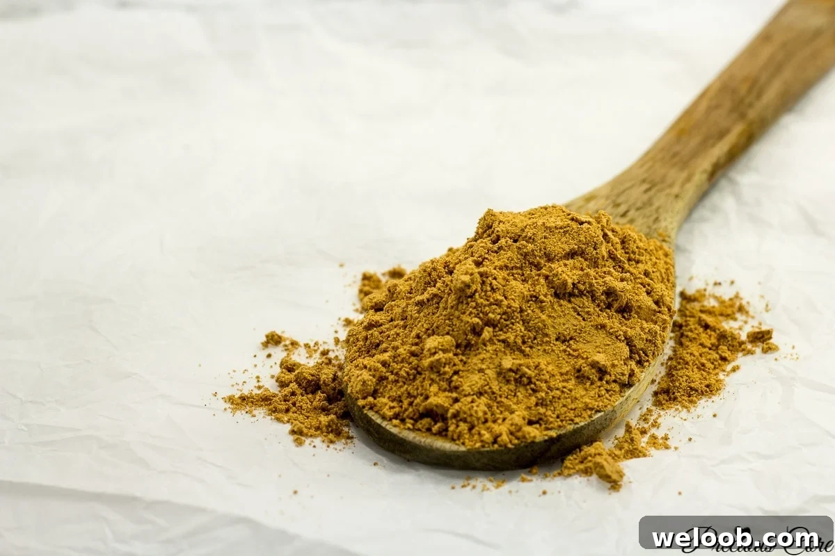 A wooden spoon filled with West African Suya spice.