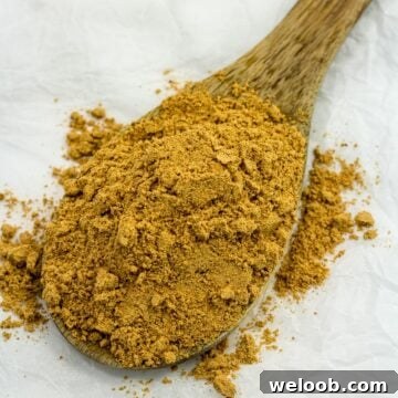 Suya spice on a wooden spoon.