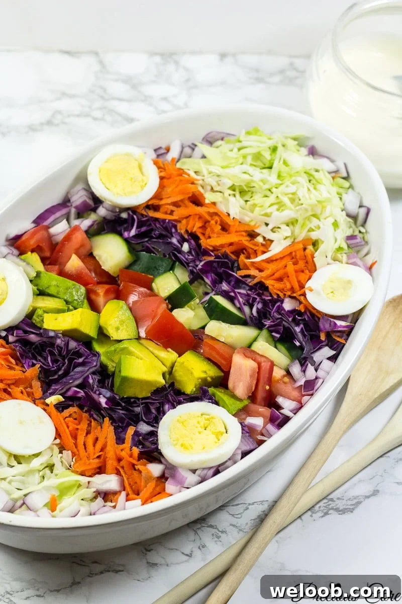 Cameroon salad with hard-boiled eggs, red onion, cucumber, and more.