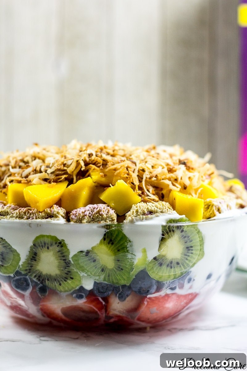 Seven layer fruit salad in a glass bowl.