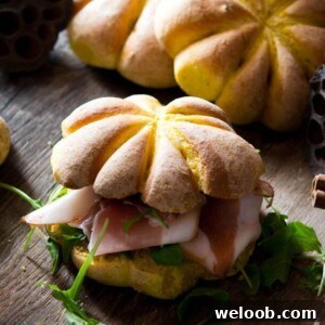 A close up of a bread roll shaped like a pumpkin