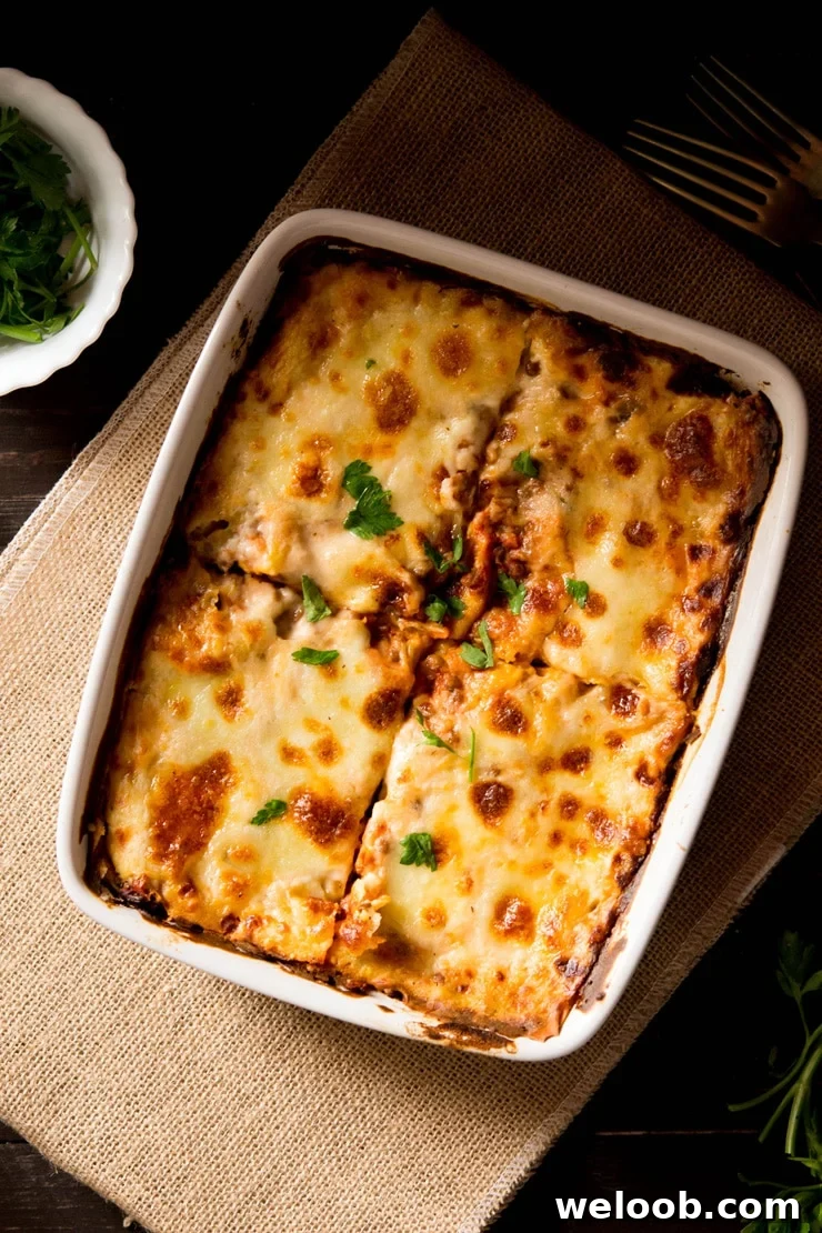 Lentil ragu lasagne in a baking dish cut into four
