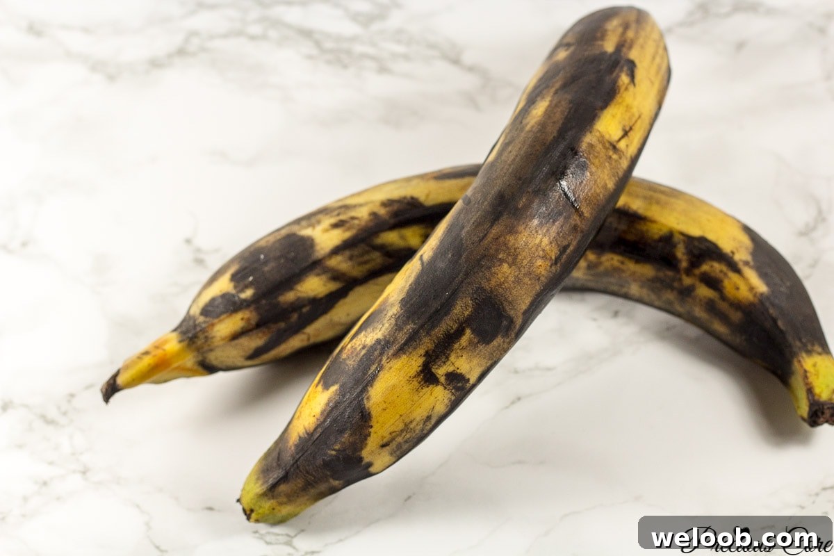 Very brown plantains on a marbled countertop.