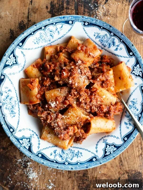 A blue and white vintage style bowl with paccheri and hazelnut ragu.