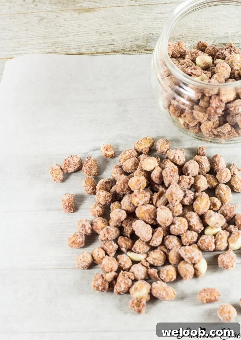 Candied nuts in and around a glass jar.