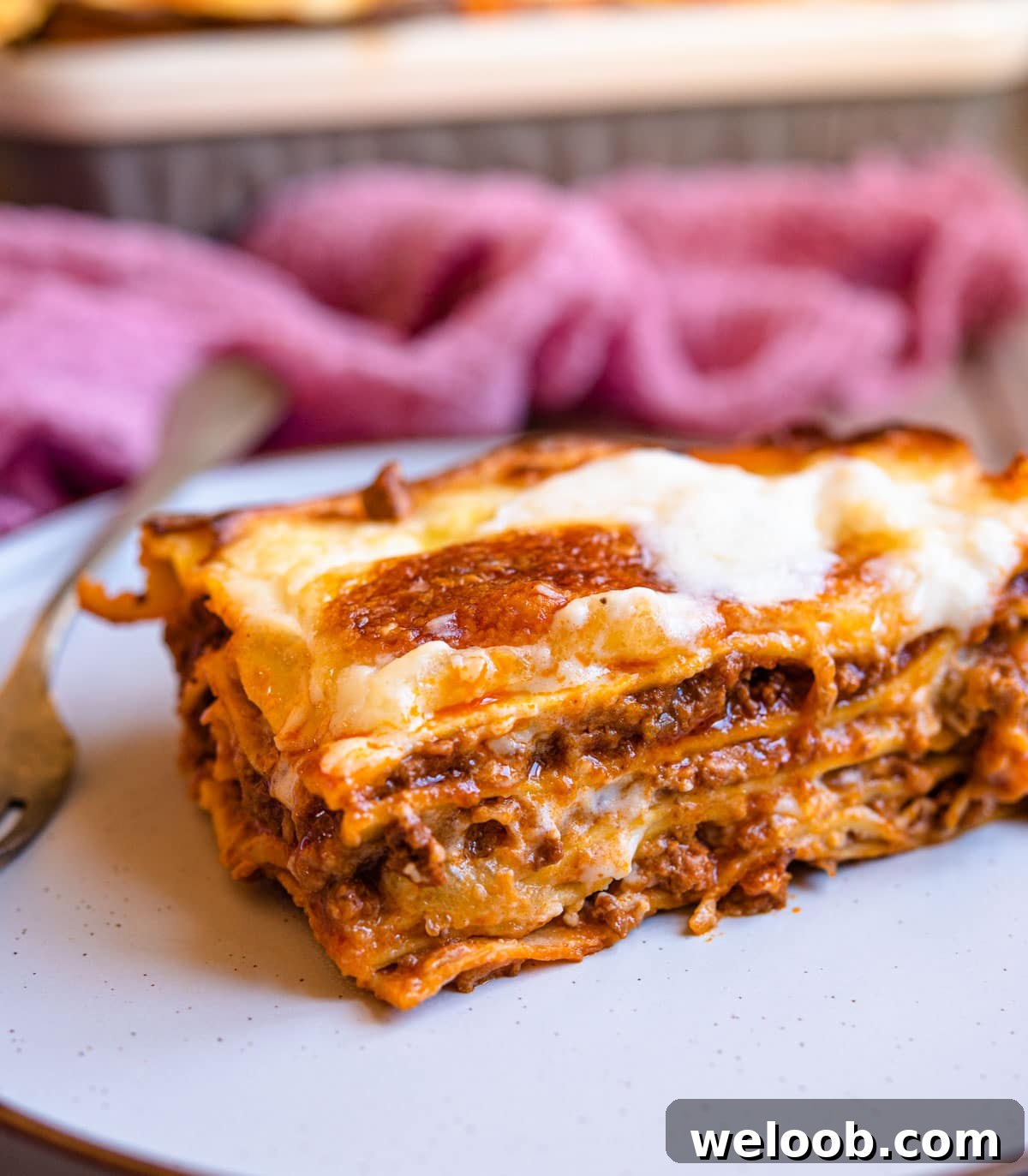 A close up of a slice of lasagne al forno on a plate