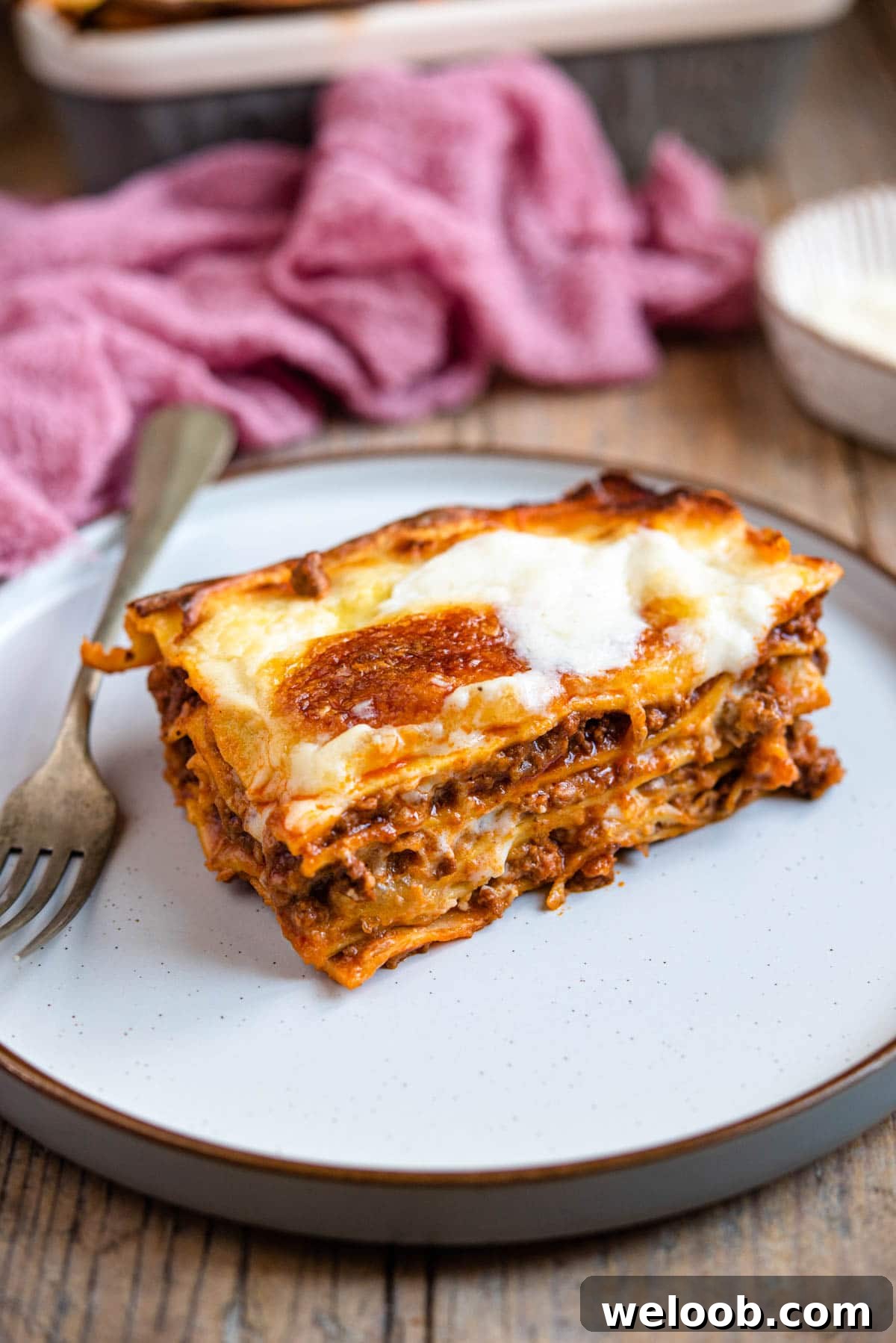 A slice of beef lasagna on a plate