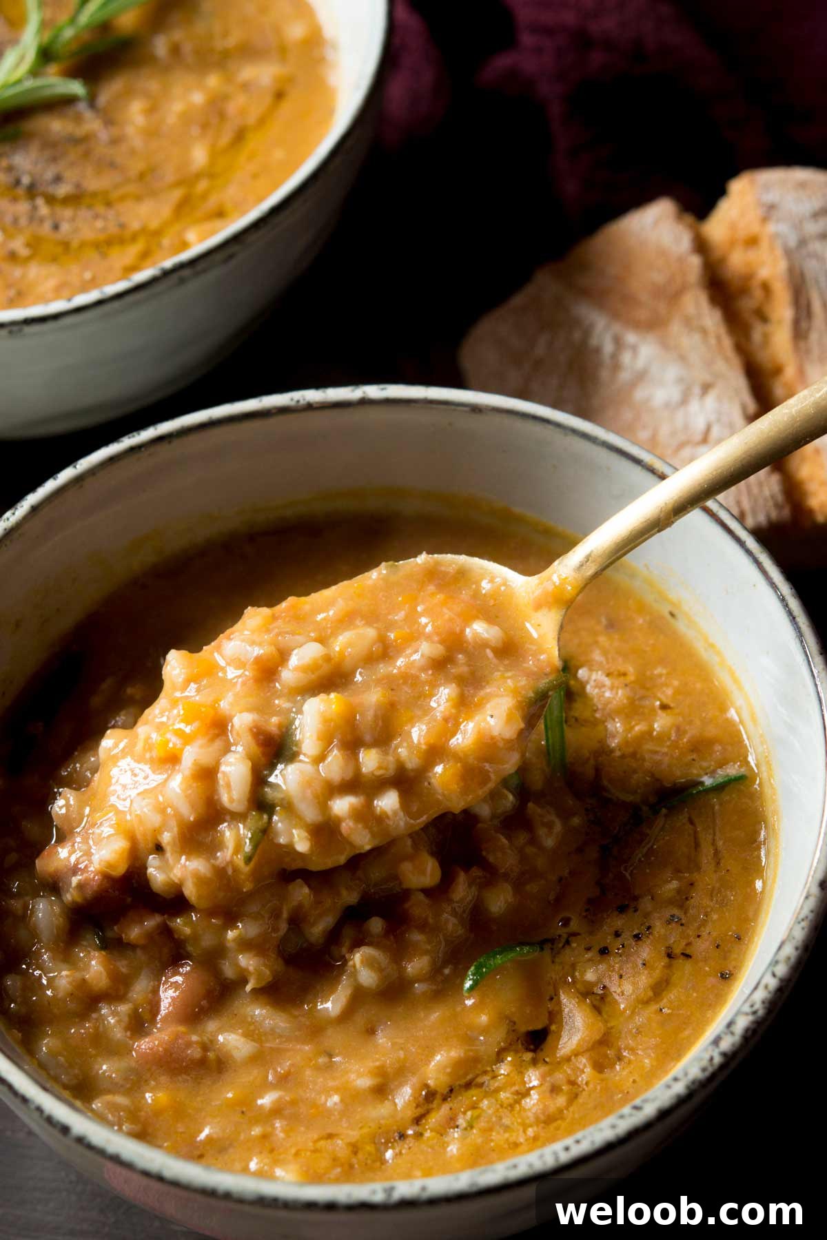 A close up of a spoonful of farro soup
