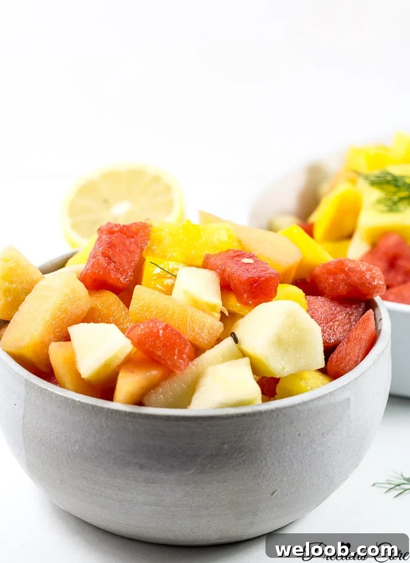 Bowl of fruit salad including watermelon, mango, and other fruit.
