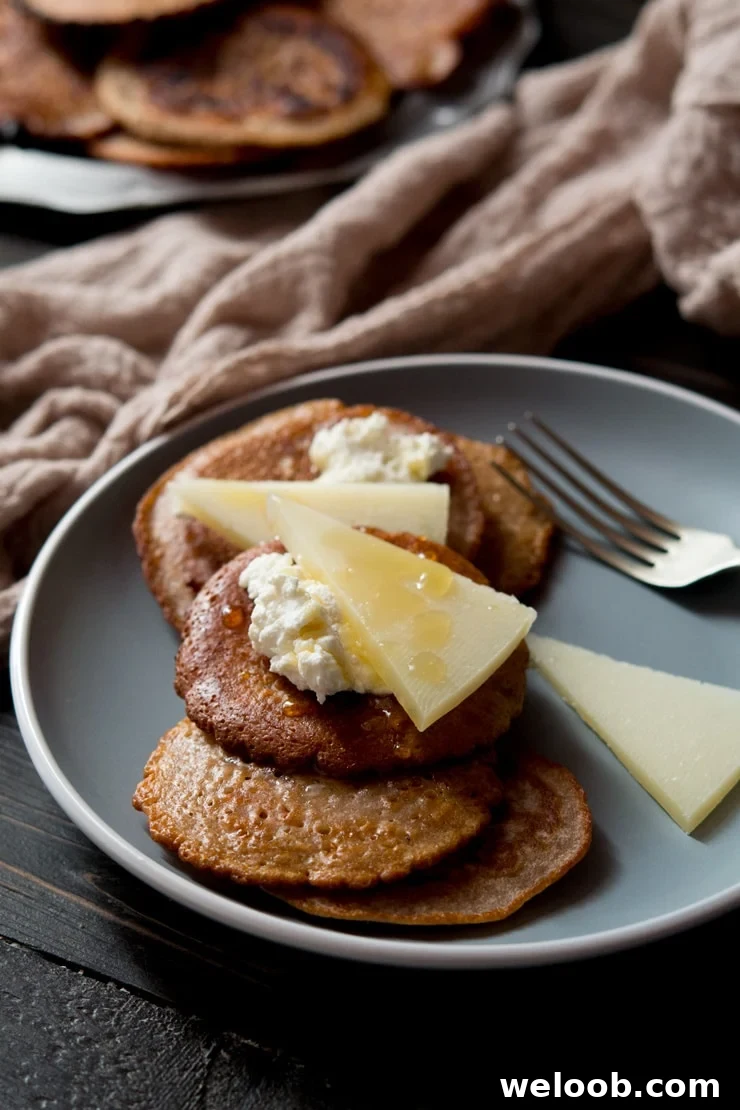 chestnut fritters topped with ricotta, pecorino cheese and honey on a blue plate