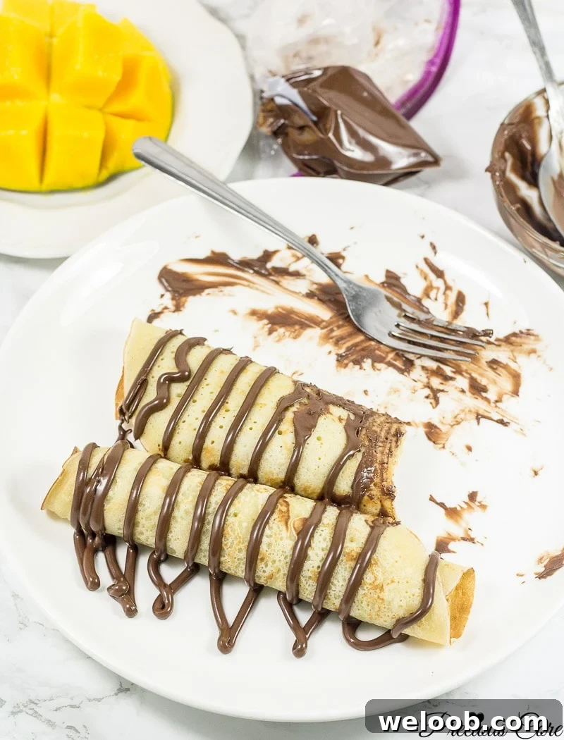 Cameroonian pancakes drizzled with chocolate.