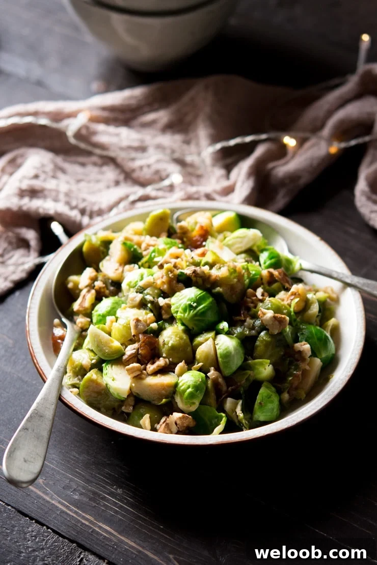 sauteed brussels sprouts with dates and walnuts on a serving plate with spoons