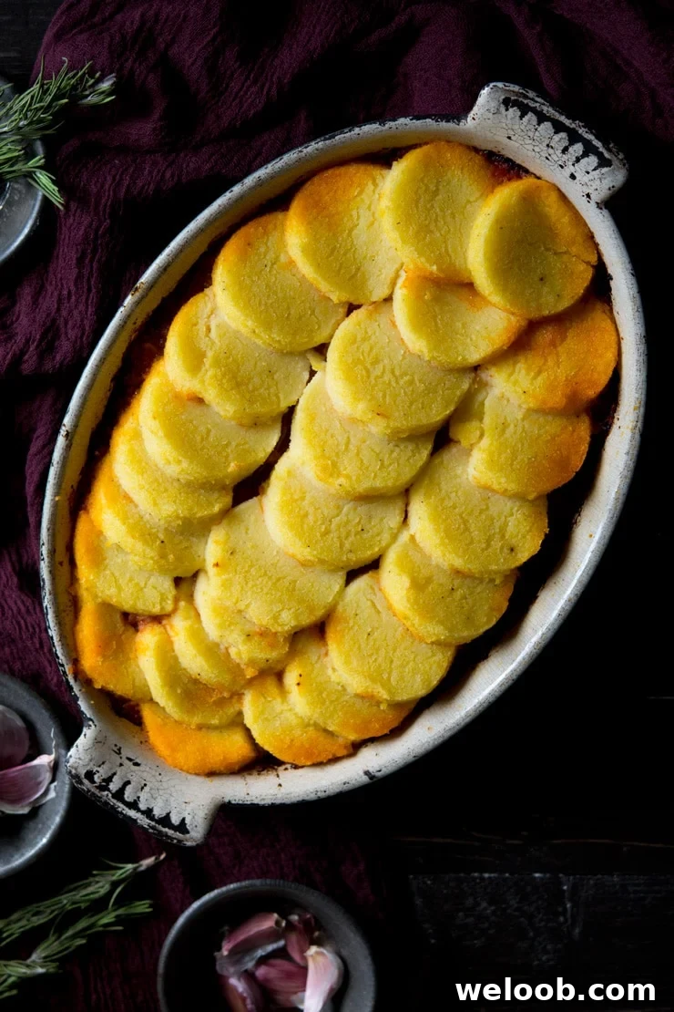 Baked polenta with sausage and beef ragu in a baking dish